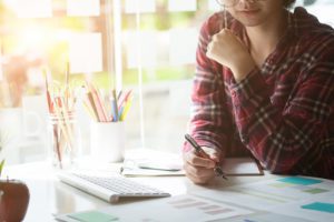 woman working on some charts on her desk