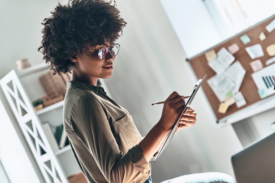 Getting Things Done. Attractive Young African Woman Writing Some