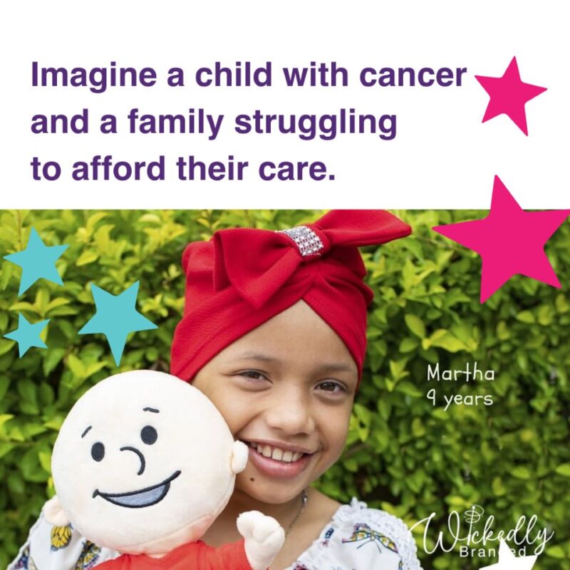 A child smiling while holding their plushie